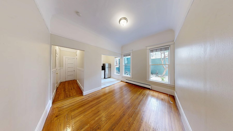 A room with wooden floors and white walls.